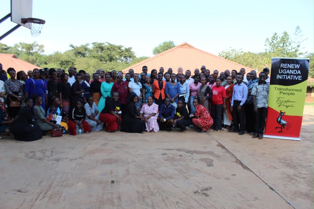 Renew Uganda educators and community with banner