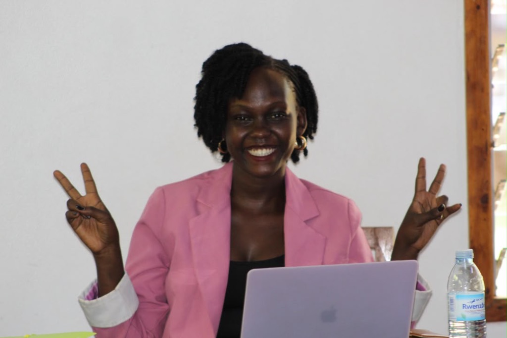 Smiling educator working on laptop
