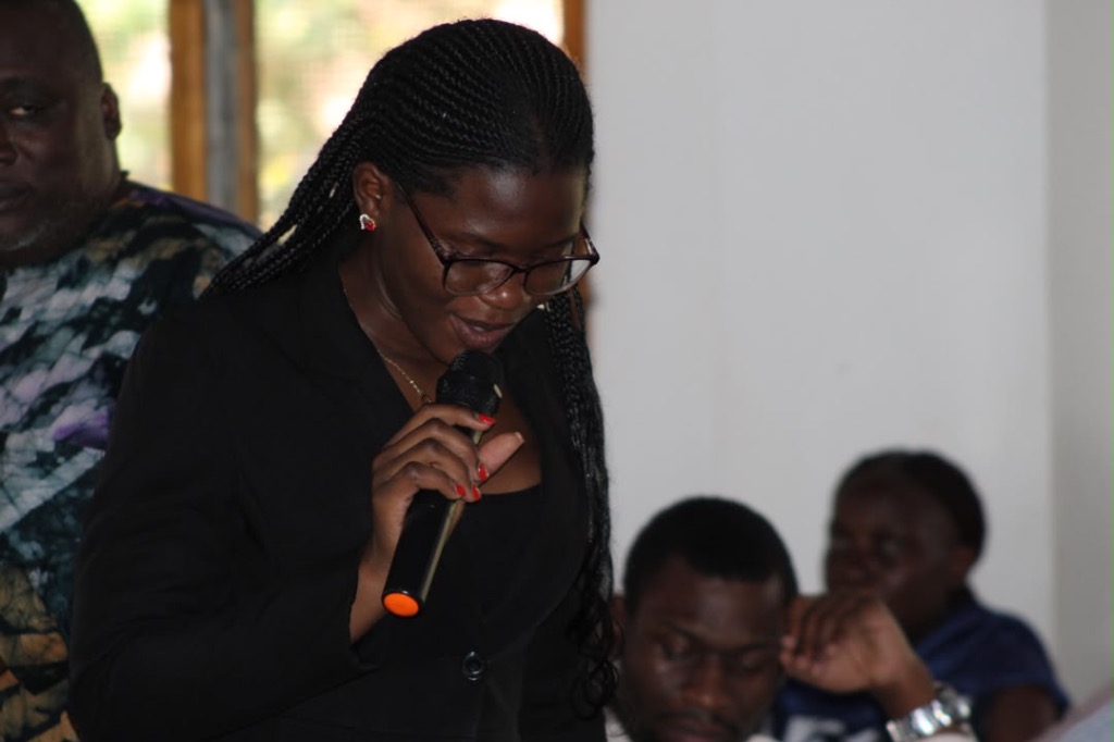 Educator speaking at Renew Uganda gathering
